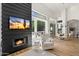 Modern living room featuring a fireplace, large windows, and views to an outdoor patio at 12055 E Clinton St, Scottsdale, AZ 85259