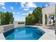 Stunning pool area surrounded by lush greenery and a covered patio with plenty of seating at 12055 E Clinton St, Scottsdale, AZ 85259