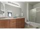 Well lit bathroom features double sinks with wood cabinets and a shower with a sliding glass door at 1330 S Aaron -- # 218, Mesa, AZ 85209