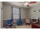 Playroom features a ceiling fan, blue curtains, and a variety of toys for children to play with at 1330 S Aaron -- # 218, Mesa, AZ 85209