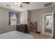 Bedroom includes blue curtains, a bookshelf, and a door leading to other parts of the home at 1330 S Aaron -- # 218, Mesa, AZ 85209
