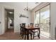 Bright dining room with a modern chandelier and sliding glass doors leading to a balcony with a view at 1330 S Aaron -- # 218, Mesa, AZ 85209