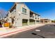 Townhouse exterior features a well-maintained facade, multiple garages, and tidy landscaping under a clear blue sky at 1330 S Aaron -- # 218, Mesa, AZ 85209