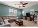 Inviting living room featuring a plush sectional sofa, media center, and ample natural light from large windows at 1330 S Aaron -- # 218, Mesa, AZ 85209