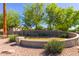 Community entrance featuring lush landscape, mature trees, and decorative stone entrance at 1330 S Aaron -- # 218, Mesa, AZ 85209