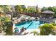 Aerial view showcasing a backyard pool, a rock waterfall, and a tropical landscape at 13514 W Banff Ln, Surprise, AZ 85379
