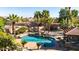Aerial view of the sparkling pool, rock waterfall, palm trees, and poolside gazebo at 13514 W Banff Ln, Surprise, AZ 85379