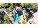 Aerial view of a backyard featuring a pool, outdoor kitchen, mature landscaping, and a covered patio at 13514 W Banff Ln, Surprise, AZ 85379