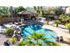 Resort-style backyard featuring a sparkling pool, covered patio, and outdoor kitchen, perfect for entertaining at 13514 W Banff Ln, Surprise, AZ 85379