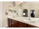 Bathroom featuring a double vanity, a large mirror, and modern fixtures at 13514 W Banff Ln, Surprise, AZ 85379