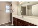 Bathroom featuring a sink, counter, mirror, and window offering natural light at 13514 W Banff Ln, Surprise, AZ 85379