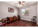 Comfortable bedroom with hardwood floors, a ceiling fan, and a large window providing natural light at 13514 W Banff Ln, Surprise, AZ 85379