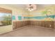 Cheery bedroom featuring a mural of a beach, carpeted floors, and a ceiling fan at 13514 W Banff Ln, Surprise, AZ 85379