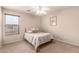 Bedroom featuring a window with blinds, neutral colors, and carpeted floors at 13514 W Banff Ln, Surprise, AZ 85379
