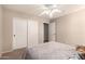 Neutral bedroom featuring a ceiling fan, carpet, and closet with sliding doors at 13514 W Banff Ln, Surprise, AZ 85379