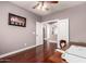 Bright bedroom featuring hardwood floors, white trim and a view into the other rooms at 13514 W Banff Ln, Surprise, AZ 85379