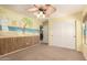 Bedroom showcasing a beach-themed mural, a ceiling fan, and a large closet at 13514 W Banff Ln, Surprise, AZ 85379