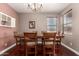 Traditional dining room featuring a wooden table, chandelier, and decorative wall art at 13514 W Banff Ln, Surprise, AZ 85379