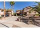 Beautiful home with a long driveway, well-manicured landscaping, and a charming exterior with stone detailing at 13514 W Banff Ln, Surprise, AZ 85379