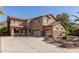 Stunning two-story home with a spacious driveway and a well-maintained front yard featuring stone accents at 13514 W Banff Ln, Surprise, AZ 85379
