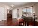 Inviting foyer with hardwood floors, a grand piano, and a view into the dining room at 13514 W Banff Ln, Surprise, AZ 85379