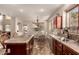 Open-concept kitchen with stainless steel appliances, dark wood cabinets, and granite countertops at 13514 W Banff Ln, Surprise, AZ 85379