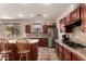 Well-lit kitchen boasts modern appliances, dark cabinets, and a functional center island at 13514 W Banff Ln, Surprise, AZ 85379