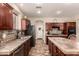 Spacious kitchen with stainless steel appliances, granite countertops, and dark wood cabinets at 13514 W Banff Ln, Surprise, AZ 85379