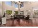 Spacious living room with high ceilings, large windows, hardwood floors, and comfortable seating at 13514 W Banff Ln, Surprise, AZ 85379