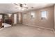 Neutral living room with natural light, carpet and staircase leading to the lower level at 13514 W Banff Ln, Surprise, AZ 85379