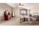 This bedroom features a ceiling fan, a window seat, and neutral wall colors at 13514 W Banff Ln, Surprise, AZ 85379