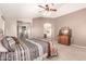 A view of the main bedroom featuring a ceiling fan, carpeted floors, and neutral colors at 13514 W Banff Ln, Surprise, AZ 85379