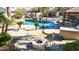 Backyard pool with rock waterfall feature, a poolside gazebo, and a cozy fire pit area at 13514 W Banff Ln, Surprise, AZ 85379