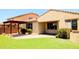 Private backyard featuring a charming pergola, green synthetic grass, and a serene outdoor space perfect for relaxation at 1437 E Flamingo Way, Gilbert, AZ 85297