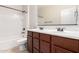 Bright bathroom features a double sink vanity with a shower and tub combination at 1437 E Flamingo Way, Gilbert, AZ 85297
