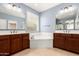 Bathroom featuring double sink vanity, soaking tub, and ample counter space at 1437 E Flamingo Way, Gilbert, AZ 85297
