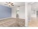 Spacious carpeted bedroom with blue accent wall and open doorway at 1437 E Flamingo Way, Gilbert, AZ 85297