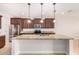 A well-lit kitchen features stainless appliances, granite counters and a large island at 1437 E Flamingo Way, Gilbert, AZ 85297