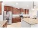 A spacious kitchen offers granite countertops, stainless steel appliances, and dark wooden cabinetry at 1437 E Flamingo Way, Gilbert, AZ 85297
