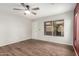 Comfortable bedroom with wood-look floors, neutral walls, and a ceiling fan at 1439 S Dodge St, Gilbert, AZ 85233