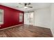 Main bedroom featuring wood-look flooring, a ceiling fan, and an en-suite bathroom at 1439 S Dodge St, Gilbert, AZ 85233