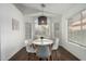 Cozy dining room featuring a modern light fixture, and views of the front yard at 1439 S Dodge St, Gilbert, AZ 85233