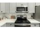 Modern kitchen with stainless steel appliances, quartz countertops, and ample cabinet space at 1439 S Dodge St, Gilbert, AZ 85233