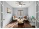 Cozy sitting room with wood floors, a ceiling fan, and ample natural light at 1439 S Dodge St, Gilbert, AZ 85233