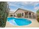 Inviting backyard featuring a sparkling blue pool and a covered patio, perfect for relaxing and entertaining at 1439 S Dodge St, Gilbert, AZ 85233