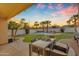 Scenic backyard with dining area overlooking the pool and well-maintained desert landscaping at 15206 S 47Th St, Phoenix, AZ 85044