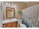 Bathroom features a single vanity and a shower with a decorative shower curtain, combining style and function at 15206 S 47Th St, Phoenix, AZ 85044