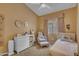 Cozy bedroom with a growth chart, chair and ottoman, and a white dresser create a comfortable space at 15206 S 47Th St, Phoenix, AZ 85044