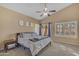 Serene bedroom showcasing a ceiling fan, natural light, and private outdoor access at 15206 S 47Th St, Phoenix, AZ 85044