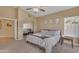 Relaxing bedroom with neutral tones, a ceiling fan, and mirrored closet doors at 15206 S 47Th St, Phoenix, AZ 85044